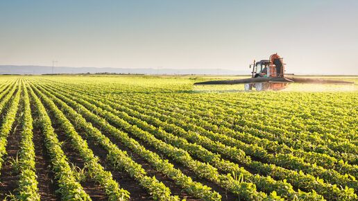 Tractor spraying pesticides on a field