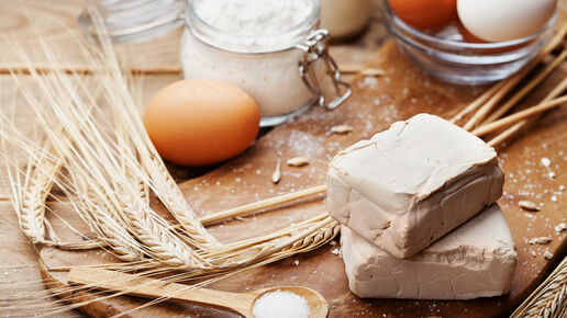 Fresh yeast and ingredients for Easter baking on rustic kitchen background